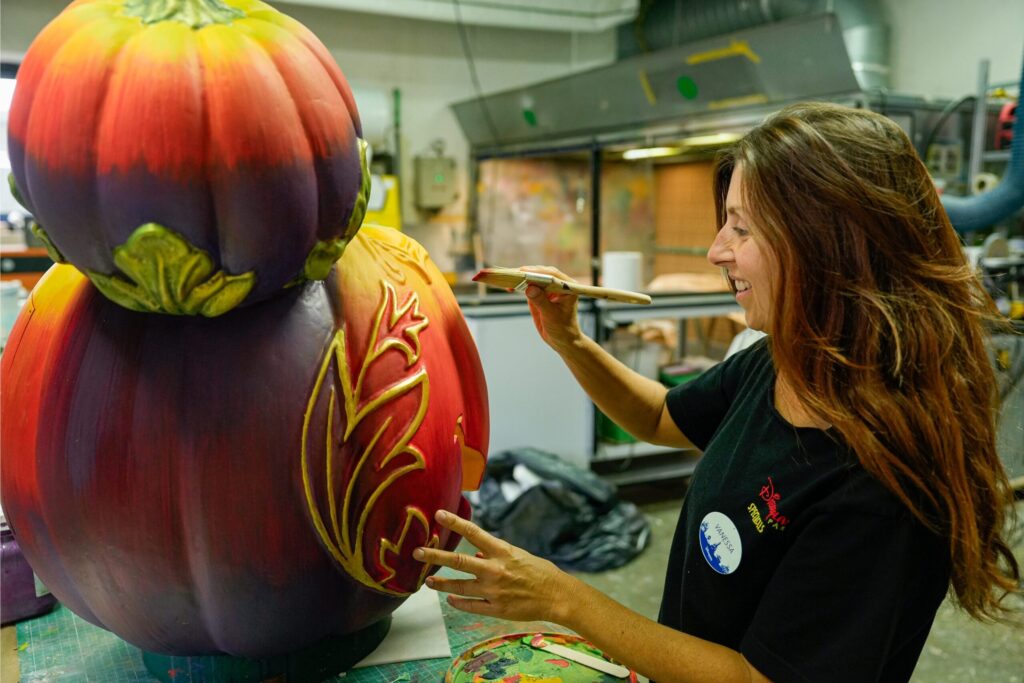 Decoração Halloween Disneyland Paris 2026 com abóbora sendo pintada