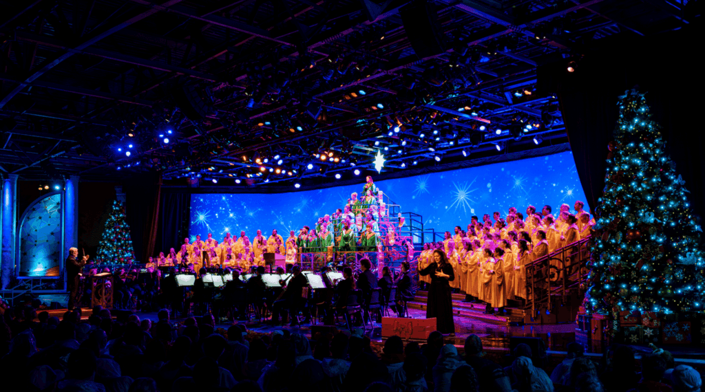 Candlelight Processional 2026 no EPCOT com coral e árvore de Natal